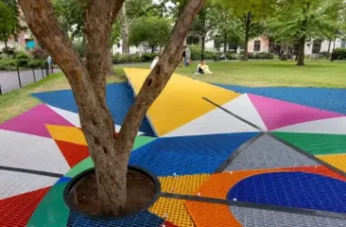 Colorful FRP grating walkway installed around trees in a public park